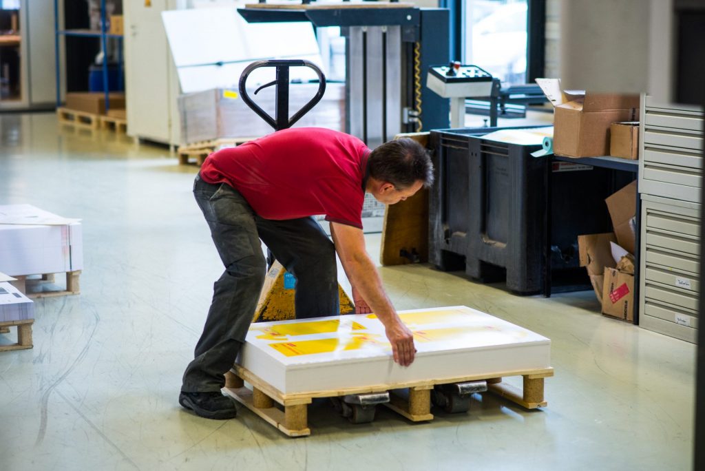 printer with printed material on pallets
